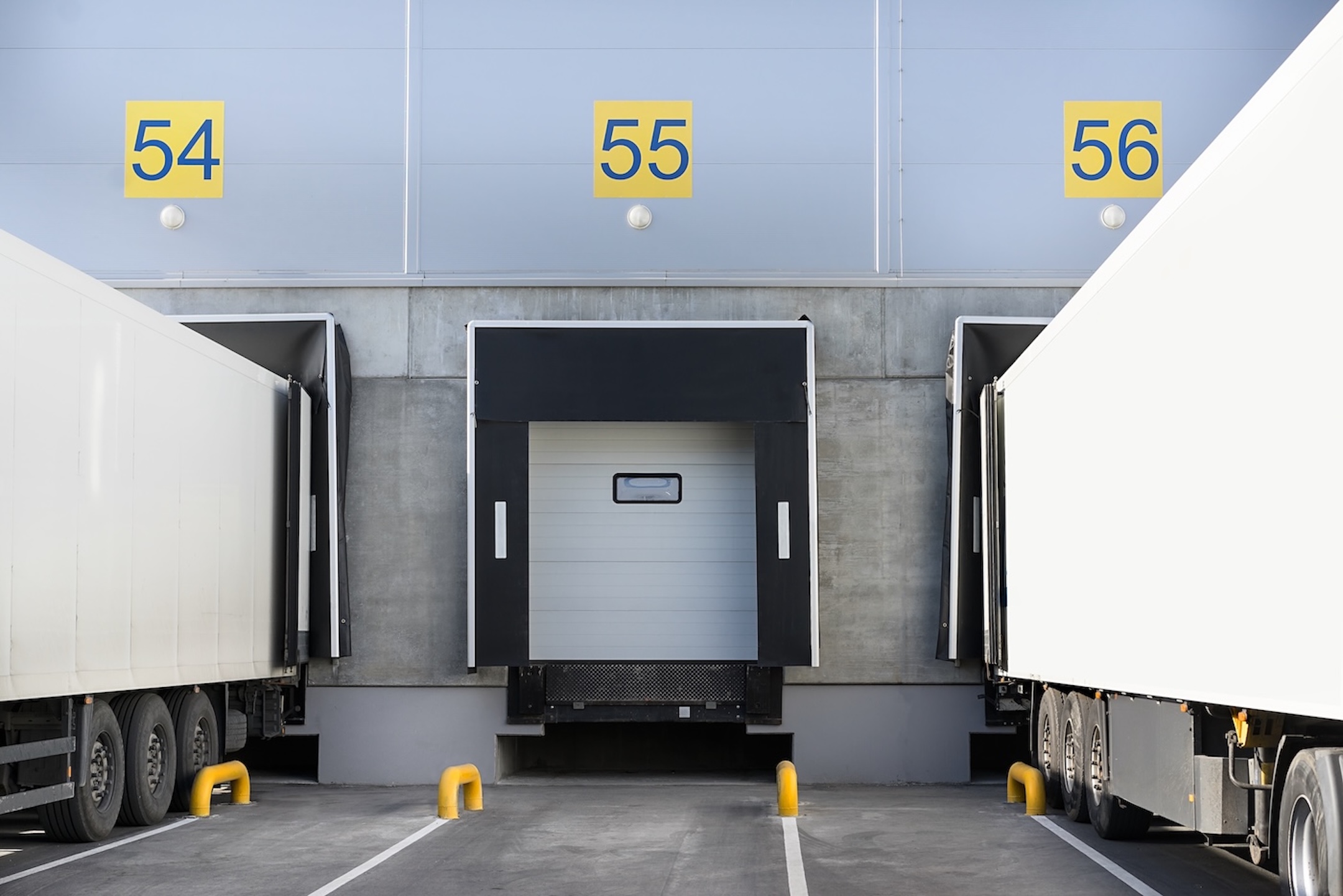 Trucks while loading in a big distribution warehouse