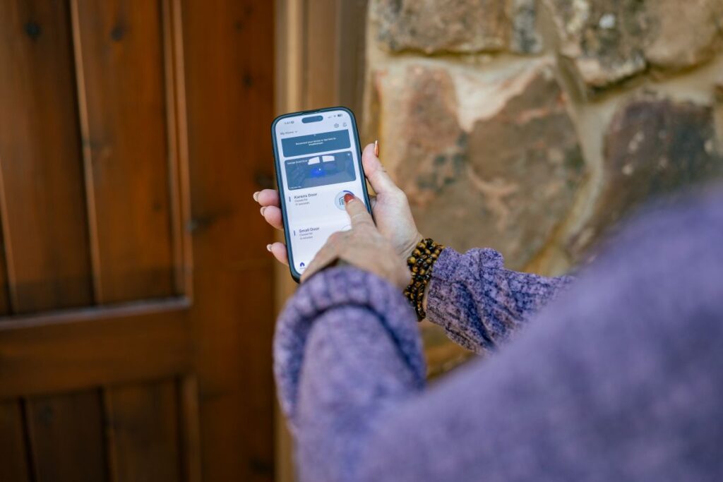 person opening garage door from a smart phone